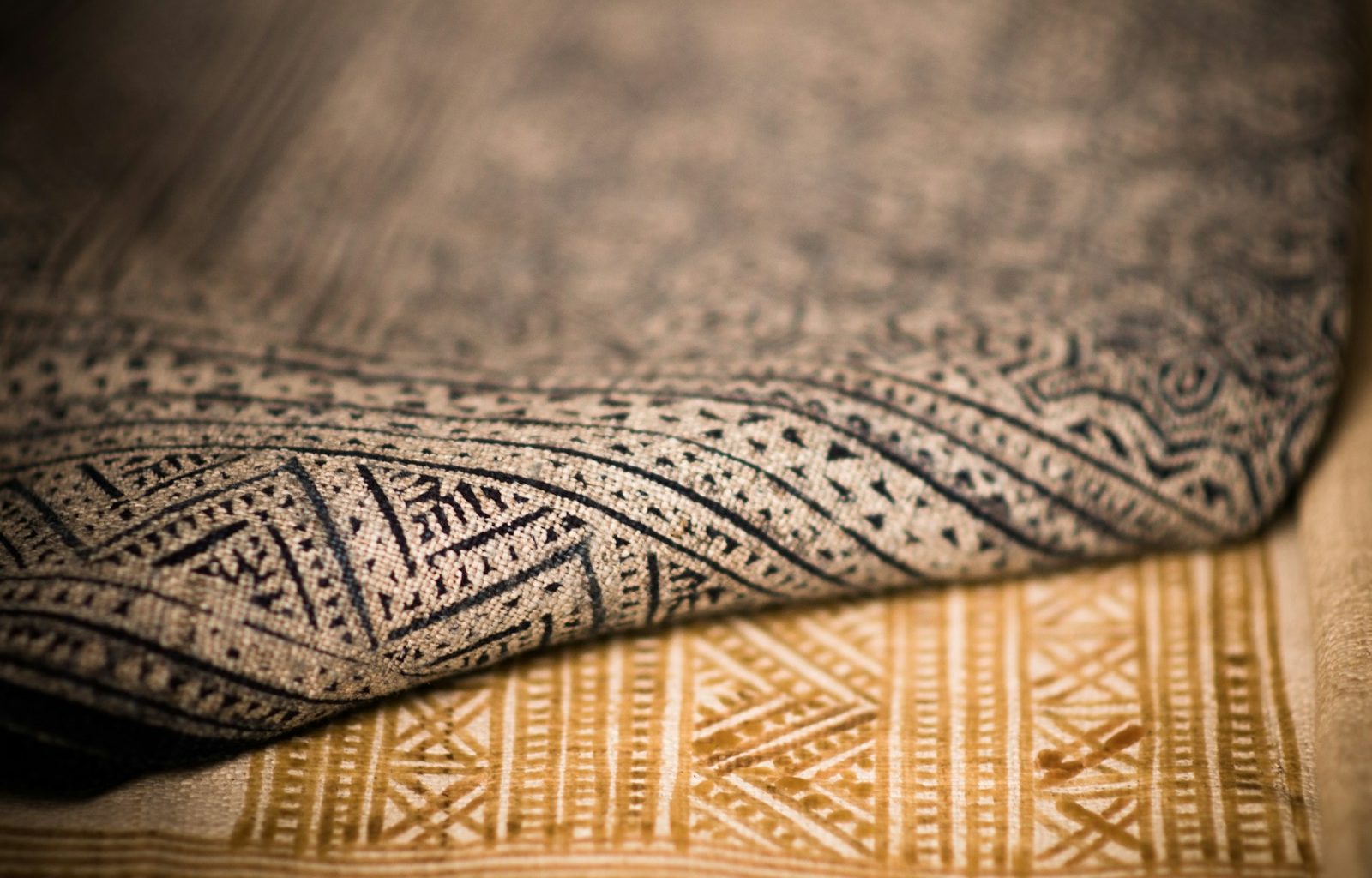 A close up that shows the texture of two different patterned rugs