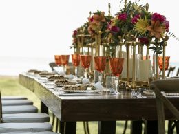 orange tinted wine glasses on rectangular brown wooden dining table