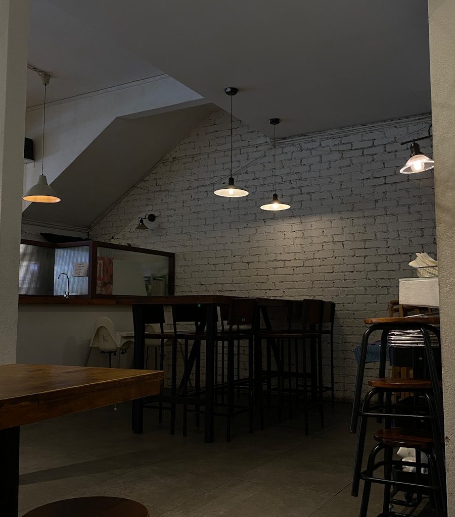 a room with a brick wall and several stools