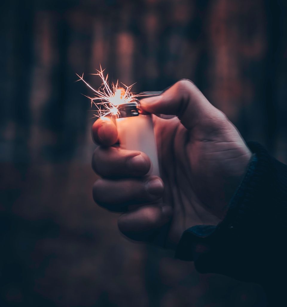 person using white disposable lighter