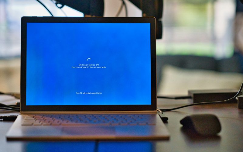 macbook pro on brown wooden table