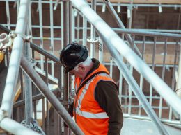 man standing under scaffoldings