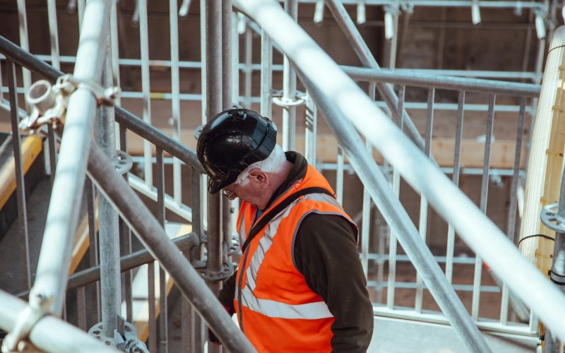 man standing under scaffoldings