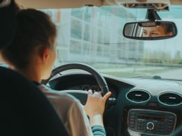 man in black shirt driving car