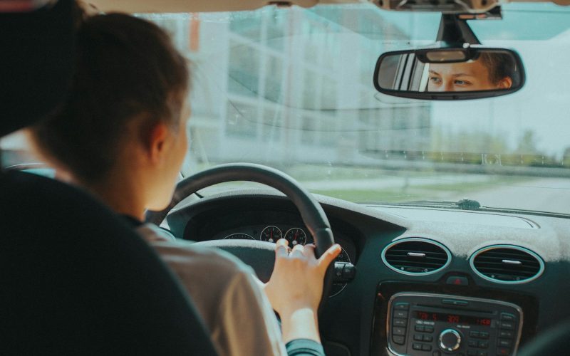 man in black shirt driving car