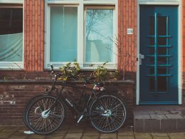 black road bicycles beside brown concrete wall during daytime