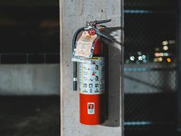 red fire extinguisher mounted on wall