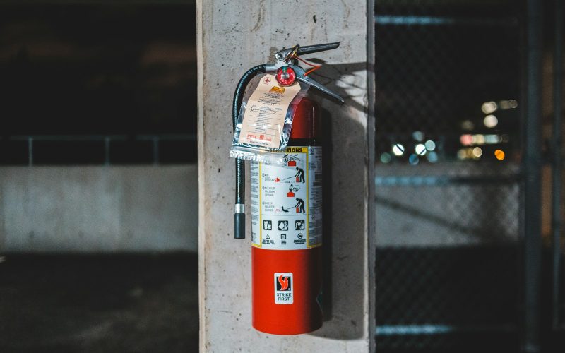 red fire extinguisher mounted on wall