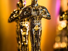 a number of oscar statues on a table