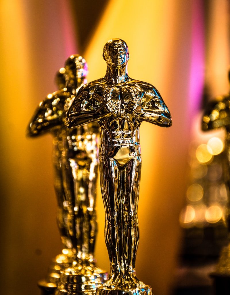 a number of oscar statues on a table