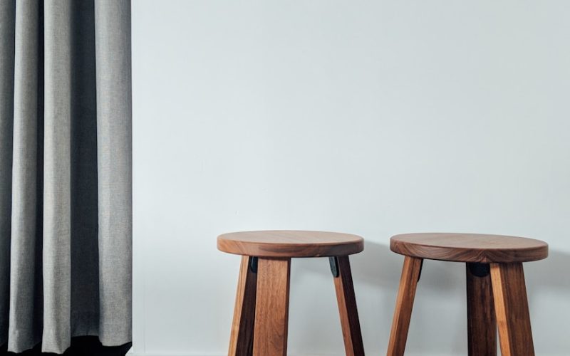 two brown wooden stools