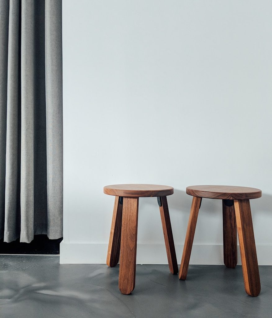 two brown wooden stools