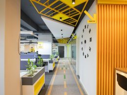 a long hallway with yellow and black accents