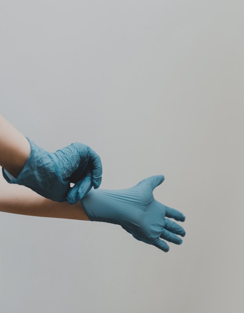 person in blue gloves and blue denim jeans